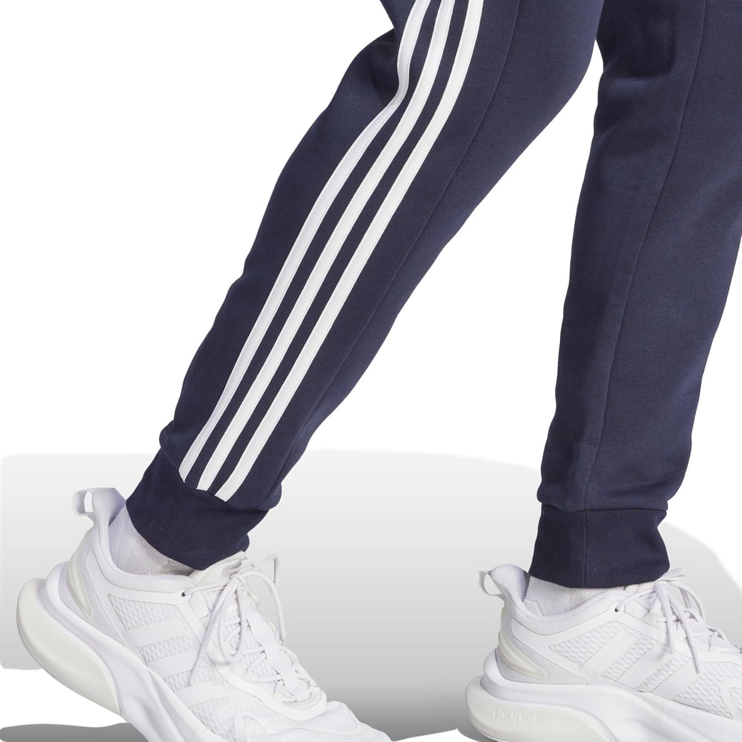 imageadidas Mens Essentials 3Stripes Fleece Tapered Cuff PantsLegend Ink