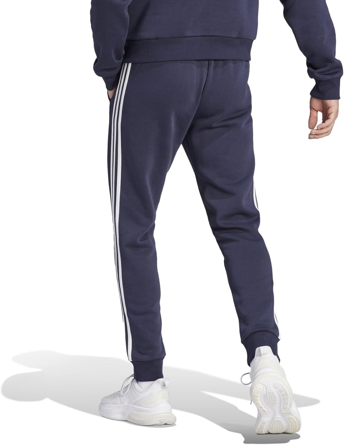 imageadidas Mens Essentials 3Stripes Fleece Tapered Cuff PantsLegend Ink