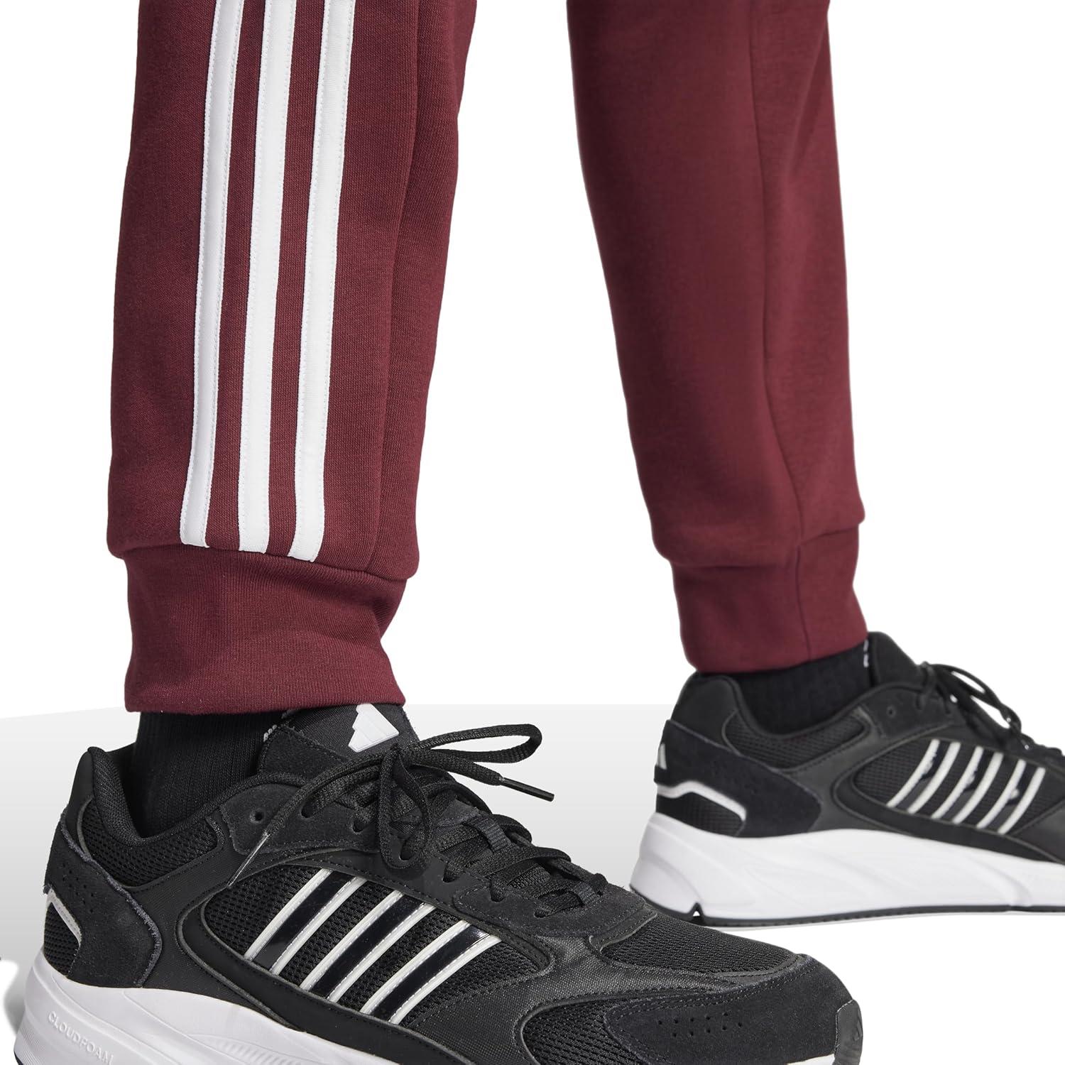 imageadidas Mens Essentials 3Stripes Fleece Tapered Cuff PantsShadow Red