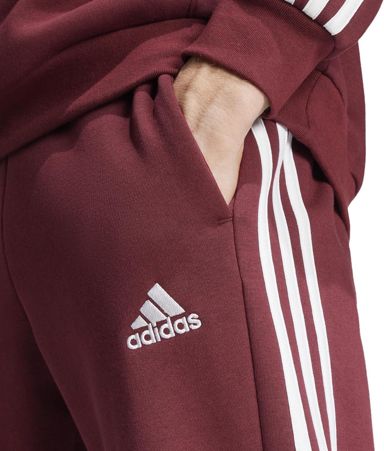 imageadidas Mens Essentials 3Stripes Fleece Tapered Cuff PantsShadow Red