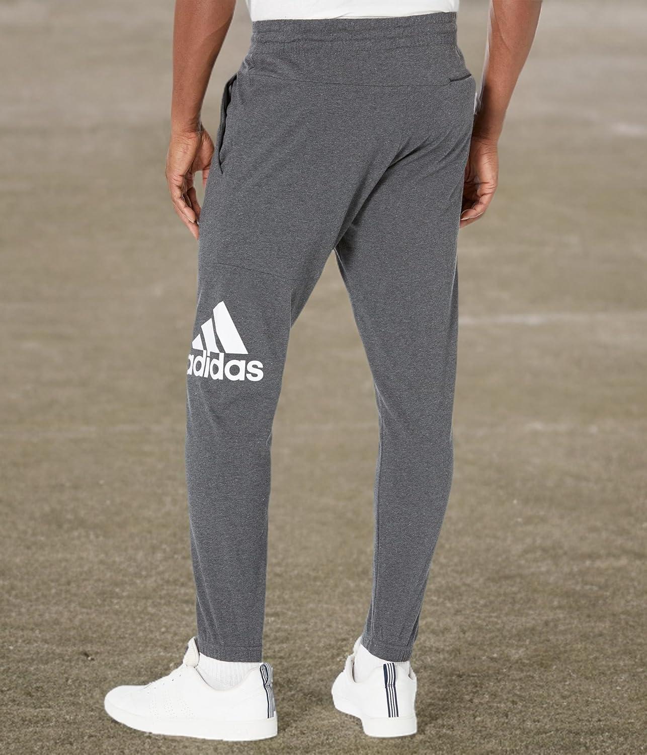 imageadidas Mens Essentials Logo Tapered Badge SweatpantsDark Grey Heather