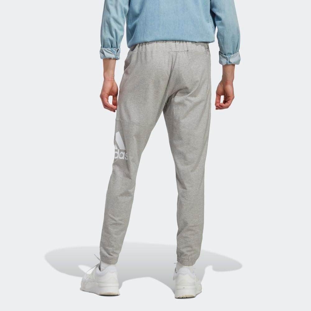 imageadidas Mens Essentials Logo Tapered Badge SweatpantsMedium Grey Heather